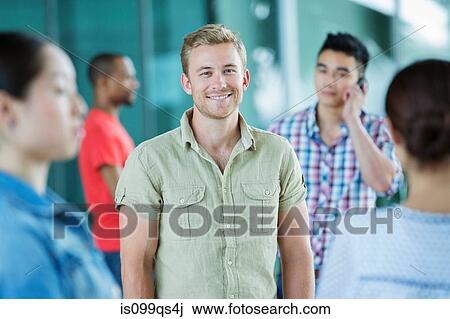 Young man in crowd View Large Photo Image Stock Image - Young man in crowd. Fotosearch
