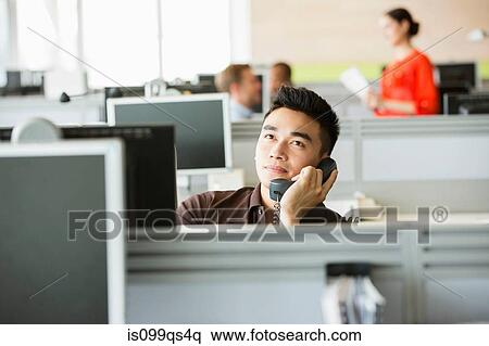 Young man on telephone in office View Large Photo Image Stock Photography - Young man on telephone in office. Fotosearch