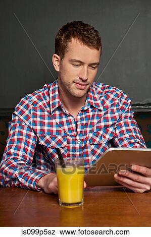 Young man with digital tablet View Large Photo Image Stock Photo - Young man with digital tablet. Fotosearch