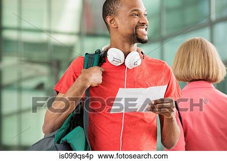 Young man with document and backpack View Large Photo Image Stock Photography - Young man with document and backpack. Fotosearch