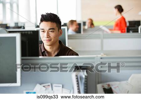 Young man working in office View Large Photo Image Stock Image - Young man working in office. Fotosearch