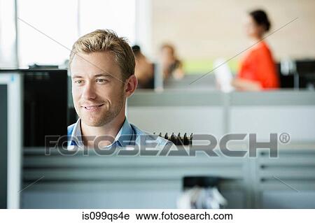 Young man working in office View Large Photo Image Stock Image - Young man working in office. Fotosearch