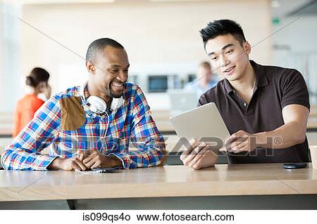 Young men in break room with digital tablet View Large Photo Image Picture - Young men in break room with digital tablet. Fotosearch
