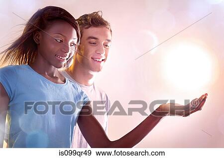 Young people holding light View Large Photo Image Stock Photo - Young people holding light. Fotosearch