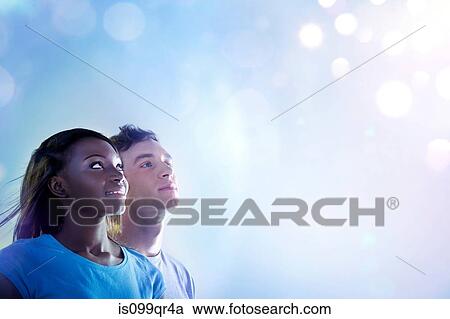 Young people looking up at light View Large Photo Image Stock Image - Young people looking up at light. Fotosearch