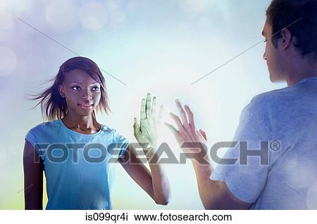 Stock Image - Young people touching light. Fotosearch
