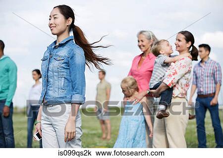 Young woman and group of people outdoors View Large Photo Image Stock Image - Young woman and group of people outdoors. Fotosearch