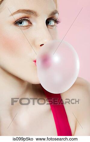 Young woman blowing bubblegum View Large Photo Image Picture - Young woman blowing bubblegum. Fotosearch