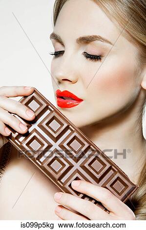 Young woman holding chocolate View Large Photo Image Stock Image - Young woman holding chocolate. Fotosearch