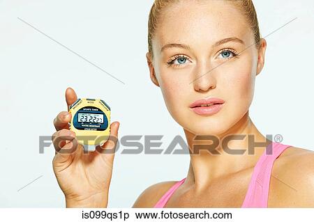 Young woman holding stop watch View Large Photo Image Stock Photography - Young woman holding stop watch. Fotosearch