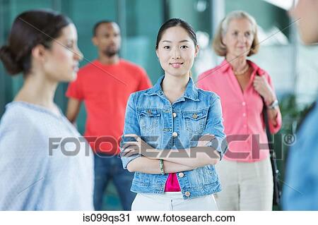 Stock Image - Young woman in a crowd. Fotosearch