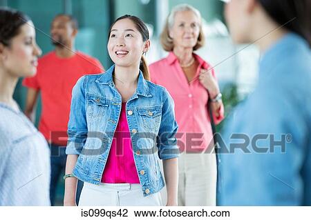 Stock Image - Young woman in crowd. Fotosearch