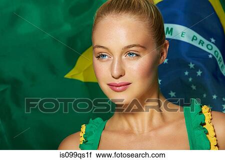 Stock Image - Young woman in front of Brazilian flag. Fotosearch