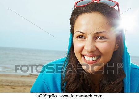 Young woman in hooded top on beach View Large Photo Image Picture - Young woman in hooded top on beach. Fotosearch