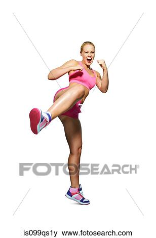 Young woman kicking out View Large Photo Image Stock Photo - Young woman kicking out. Fotosearch