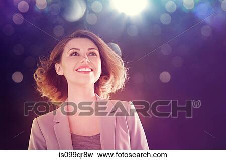 Young woman looking up at lights View Large Photo Image Stock Photo - Young woman looking up at lights. Fotosearch