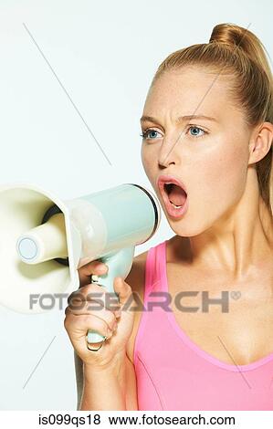 Young woman shouting through megaphone View Large Photo Image Stock Photo - Young woman shouting through megaphone. Fotosearch