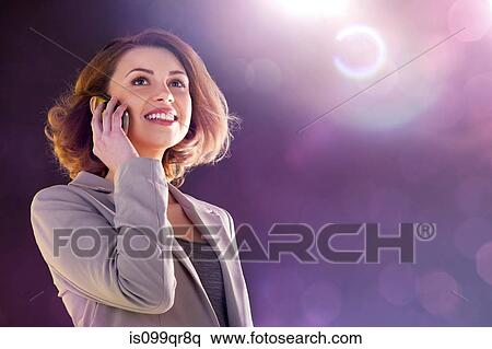 Stock Photography - Young woman using cellphone. Fotosearch