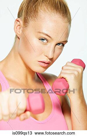 Young woman using hand weights View Large Photo Image Stock Image - Young woman using hand weights. Fotosearch
