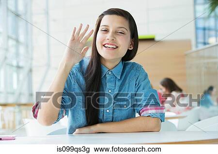 Young woman waving at camera View Large Photo Image Stock Image - Young woman waving at camera. Fotosearch