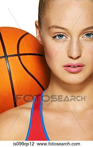 Stock Image - Young woman with basketball. Fotosearch