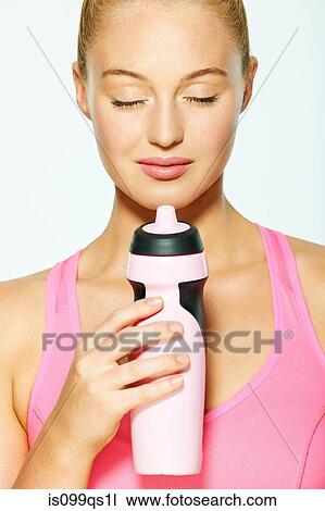 Young woman with eyes closed, holding water bottle View Large Photo Image Stock Image - Young woman with eyes closed, holding water bottle. Fotosearch