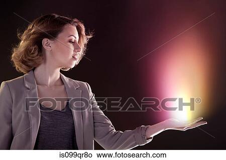Young woman with light in her hand View Large Photo Image Picture - Young woman with light in her hand. Fotosearch