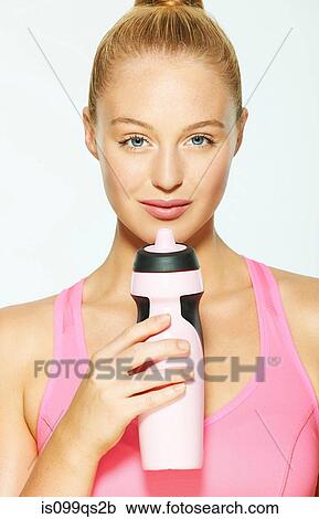 Stock Image - Young woman with water bottle. Fotosearch