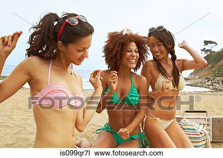 Young women on beach with stereo View Large Photo Image Stock Image - Young women on beach with stereo. Fotosearch