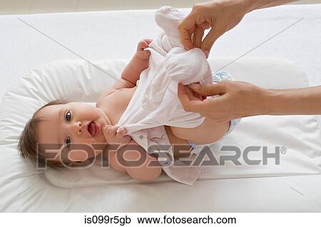 Baby girl being changed on mat View Large Photo Image Stock Image - Baby girl being changed on mat. Fotosearch
