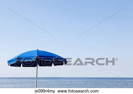 Blue parasol against the sea View Large Photo Image Stock Photo - Blue parasol against the sea. Fotosearch