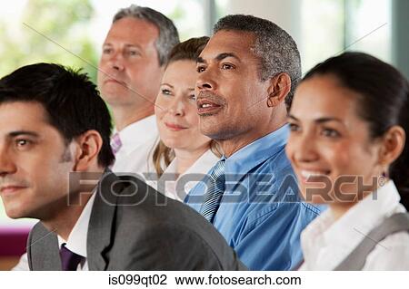 Stock Image - Businesspeople at presentation. Fotosearch
