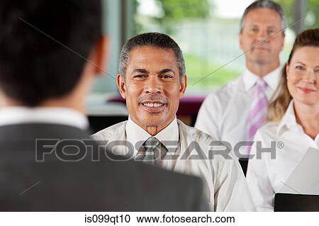 Stock Image - Businesspeople at presentation. Fotosearch