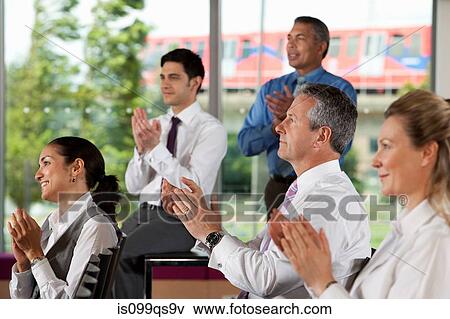 Stock Photo - Businesspeople clapping at meeting. Fotosearch