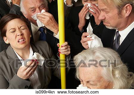 Businesspeople sneezing on subway train View Large Photo Image Picture - Businesspeople sneezing on subway train. Fotosearch