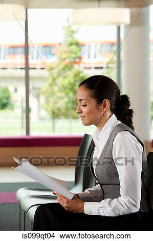 Businesswoman reading document, side view View Large Photo Image Picture - Businesswoman reading document, side view. Fotosearch