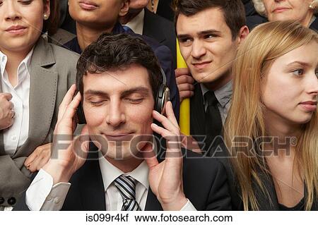 Businesswoman wearing headphones on subway train View Large Photo Image Stock Image - Businesswoman wearing headphones on subway train. Fotosearch