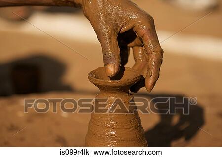 Close up of potter at work in Orchha, Madhya Pradesh, India View Large Photo Image Stock Image - Close up of potter at work in Orchha, Madhya Pradesh, India. Fotosearch