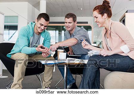 Colleagues looking at digital tablet View Large Photo Image Stock Photography - Colleagues looking at digital tablet. Fotosearch