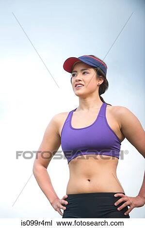 Female runner with hands on hips View Large Photo Image Stock Image - Female runner with hands on hips. Fotosearch
