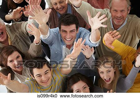 Stock Image - Group of people with arms raised, high angle. Fotosearch