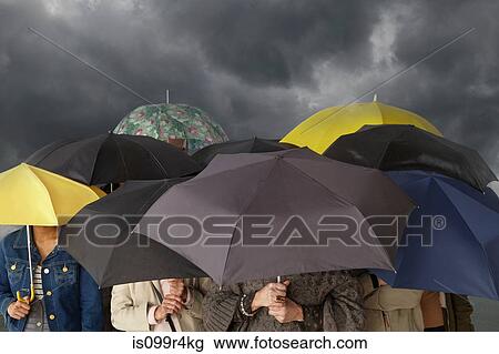 Group of people with umbrellas View Large Photo Image Stock Image - Group of people with umbrellas. Fotosearch