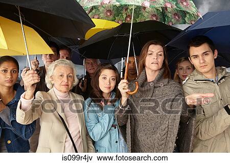 Stock Photo - Group of people with umbrellas. Fotosearch