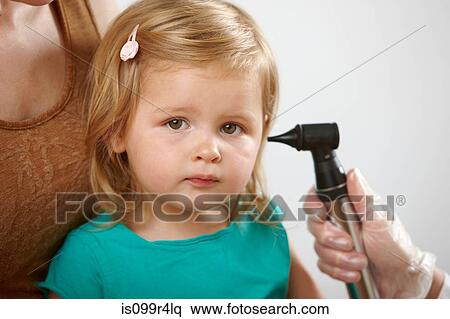 Little girl having her ear checked View Large Photo Image Stock Photography - Little girl having her ear checked. Fotosearch