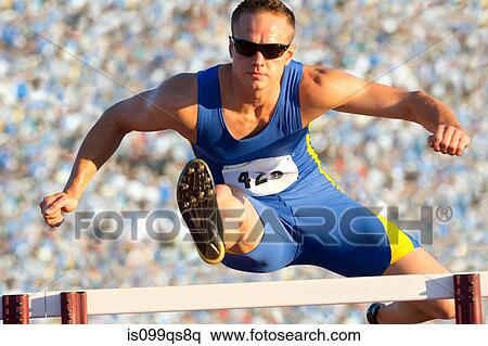 Stock Photography - Male hurdler cleaning hurdle. Fotosearch