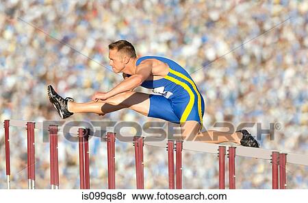 Stock Photography - Male hurdler cleaning hurdle. Fotosearch