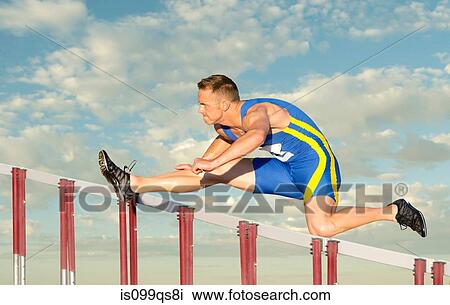 Male hurdler clearing hurdle View Large Photo Image Stock Image - Male hurdler clearing hurdle. Fotosearch
