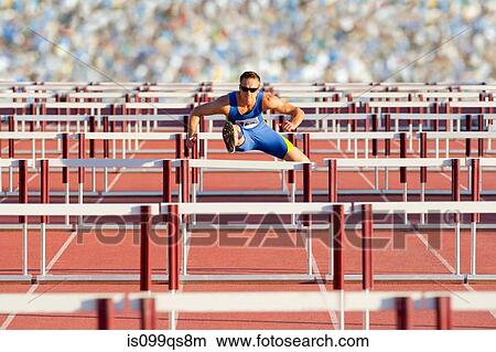 Male hurdler clearing hurdles View Large Photo Image Picture - Male hurdler clearing hurdles. Fotosearch