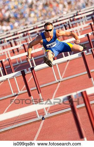 Male hurdler clearing hurdles View Large Photo Image Picture - Male hurdler clearing hurdles. Fotosearch