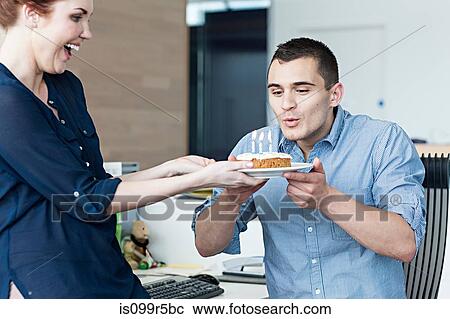 Man blowing out candles on birthday cake View Large Photo Image Stock Image - Man blowing out candles on birthday cake. Fotosearch